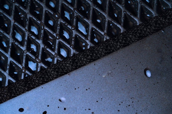 stock-photo-new-all-season-all-weather-black-car-mat-detail-with-water-drops-2219245019-transformed